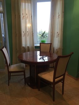 Dining table in the kitchen of the luxury apartment on bazhana. book on wellcome24 for a promotion.